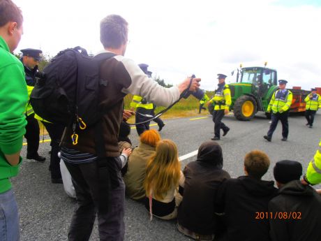 the guards directing the tractor to drive off the road