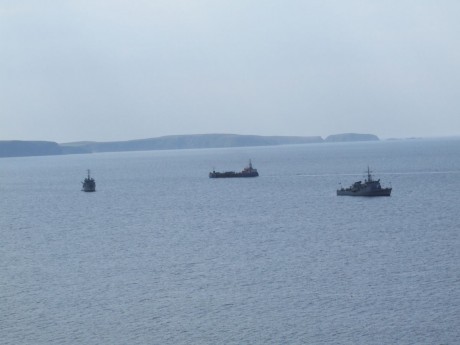 Three Shell boats - a winching barge and two War Boats