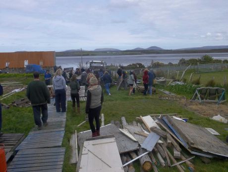 Lots of people moving pallets