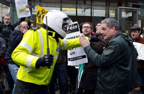 Gardai push protesters, including Sinn Fein TD Aengus O Snodaigh (right), back after they pushed through the gates of Government Buildings